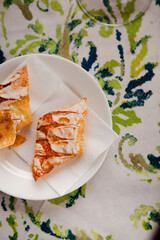 Italian food. Traditional sweet pastry made of sugar dough with jam filling in northern Italy in Salo, Lombardy region. Two pieces of cookies on a white plate on a table with a colorful tablecloth.