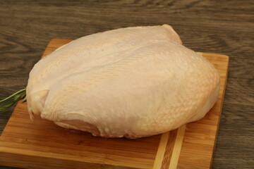 Raw whole chicken breast with skin