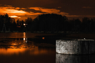 A well on the lake at sunset.