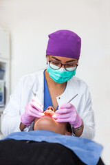 Dentist with glasses and mask during the patient's treatment in a dental office