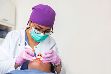 Dentist with glasses and mask during the patient's treatment in a dental office