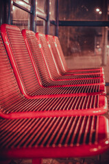 Red seats at the train station. - obrazy, fototapety, plakaty