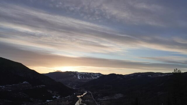 Sunset in the mountains. Sun peaks out from the sky before it sets behind again. Time lapse. Shot in Hallingdal, Norway during Easter.