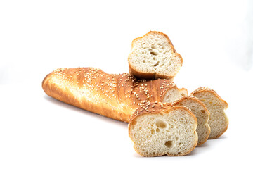 Appetizing baguette and a few slices sliced ​​with sesame seeds on a white background
