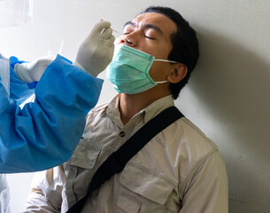 A doctor swabs the patient's nose