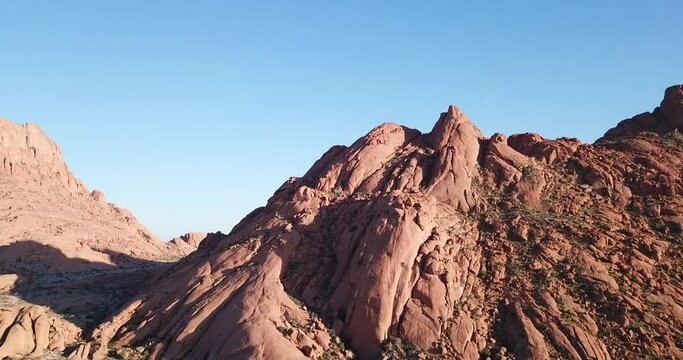 4K sunrise aerial footage of savanna, famous red granite Spitzkoppe Peak and Pontok Mountains in central Namibia between interior town Usakos and Atlantic west coast, southern Africa