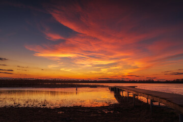 beautiful, fabulous sunset over the frozen lake and the pier - Lake Rotcze