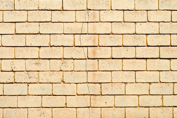 Texture of a brick wall with cracks and scratches which can be used as a background