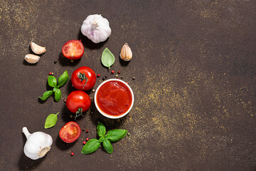 Homemade tomato sauce and ingredients for it on dark rustic background. Culinary blog social media banner.