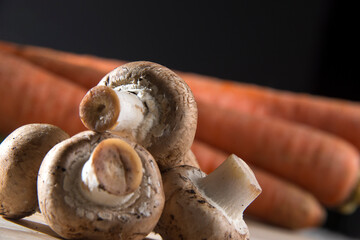 White mushroom on wood cutting board