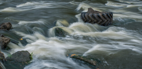 Blur the movement of water among the stones. Stingray in the river. Long exposure photography.
