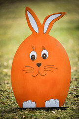 Wooden rabbit sitting in the park. Easter decoration