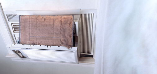 The dirty air conditioner home window filter with white copy space.