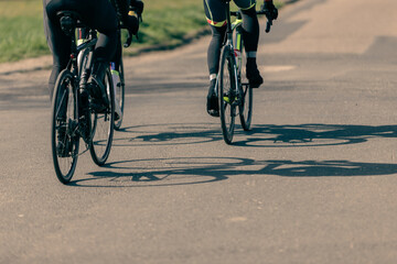 Fototapeta premium bicycles and shadows, thre people doing sports