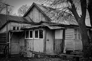 An old, wooden village house. Monochrome photo