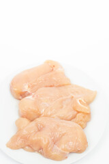 Raw Chicken Breasts on the plate above white background