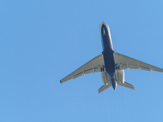 transport plane flies in the blue cloudless sky