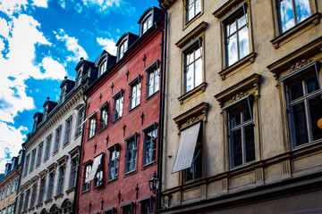 Fototapeta na wymiar Beautifully Colored Traditional Buildings Line the Narrow Cobblestone Streets Buildings in the Gamla Stan Neighborhood of Stockholm, Sweden