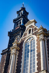 Fototapeta na wymiar Looking up at the Famous Westerkerk Church from the Canals below in Amsterdam, Netherlands
