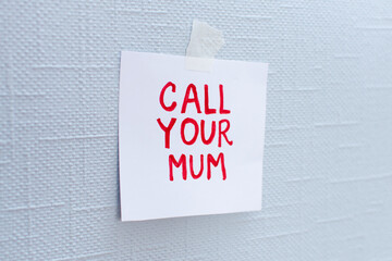 Text Call your mum sticker hanging on the wall . Social concepts don't forget about mommy. Lonely old people