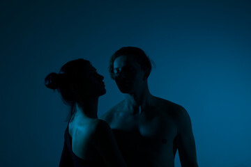 silhouette of a couple. Erotica couple. Neon light. Photo. 