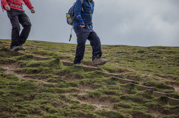 two people walking from the hill