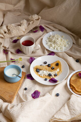 beautiful breakfast with pancakes and cottage cheese and berries