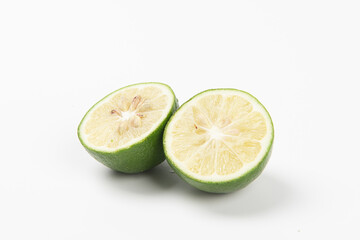 Naklejka na ściany i meble Juicy slice of lime isolated on white background