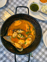 mussels au marinara served in a black platter