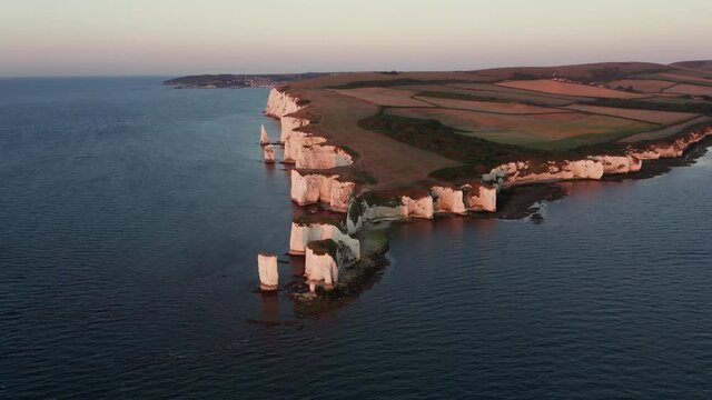 Wide aerial around the famous Old Harry white chalk headland in Dorset, England's Jurassic coast at sunrise
