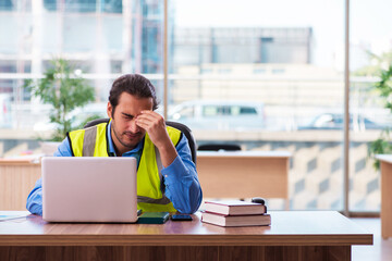 Young male architect working in the office
