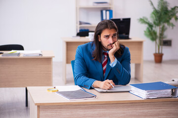 Young male employee working at workplace