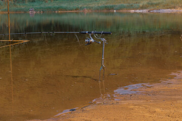 Fishing rod alone by the lake