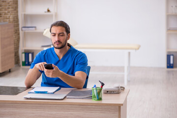 Young male doctor in telemedicine concept