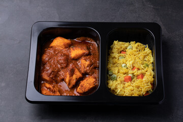 Chicken Tikka Masala and Turmeric Rice Indian cuisine in black box