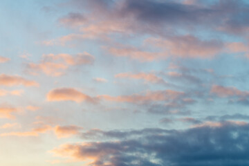 Blue sky day with pink textured, toned and colored clouds great for sky replacement with dramatic sky view. 