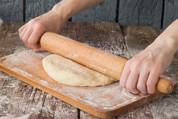 Empty space for text. Rolling out the dough on the table.