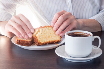 Empty space for the text. Breakfast in a cafe. Coffee, cupcake, hands.