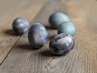 Painted chicken eggs on surface of wooden planks