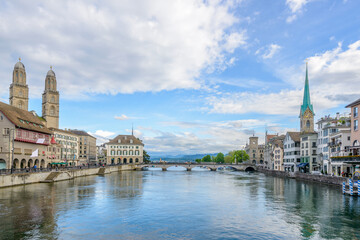 Beautiful view of historic city center of Zurich with river Limmat on a sunny day with blue sky and clouds in summer, Canton of Zurich, Switzerland.