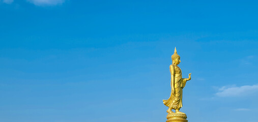 Fototapeta premium The standing buddha with blue sky and cloud,Copy space