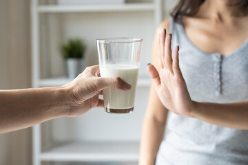 person refuse to drink milk because lactose intolerance. - obrazy, fototapety, plakaty
