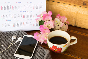 calendar, mobile phone and coffee of lifestyle arrangement flat lay style on backgrond wooden