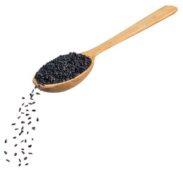 black sesame seeds falling from wooden spoon