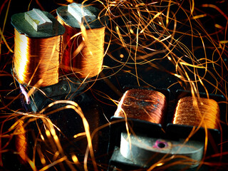 Electricity transformer with unwound copper winding on black background