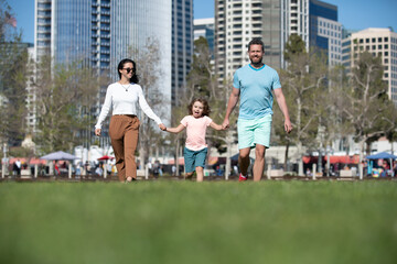 Family in the city. Family walking in urban park. Concept of children and parents, happy family.