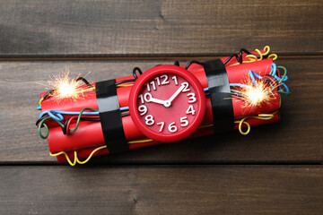 Dynamite time bomb on wooden table, top view