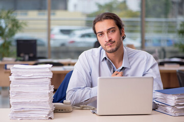 Fototapeta premium Young male employee working in the office
