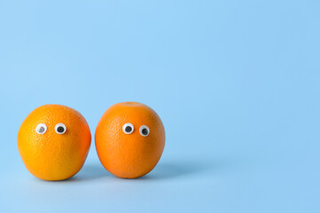 Funny orange fruit on color background