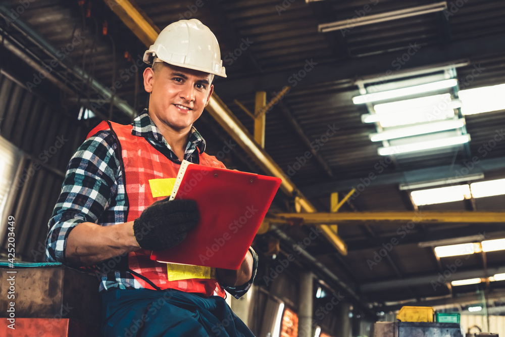 Poster manufacturing worker working with clipboard to do job procedure checklist . factory production line 
